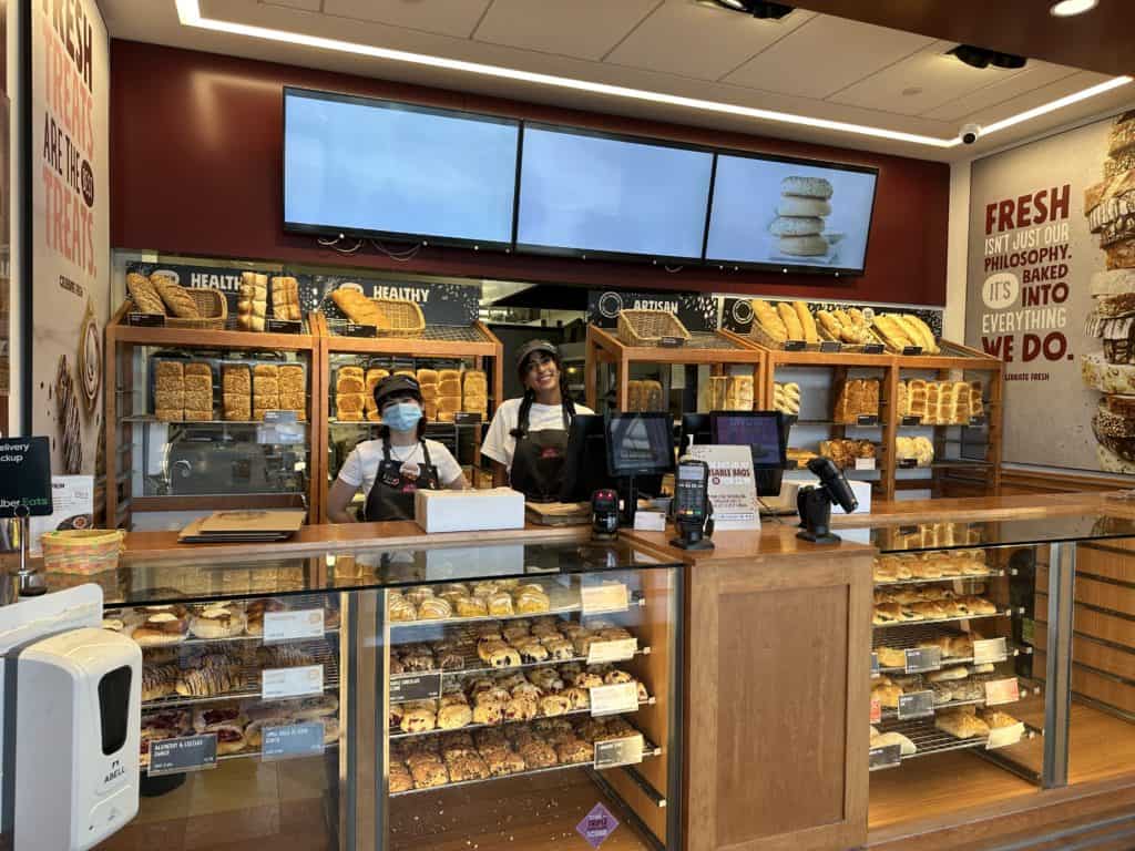 Inside Cobs Bakery  on Upper Middle Rd., Oakville two employees smile for the camera